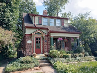 a red brick house with a red front door