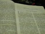 An open book written in Tagalog, specifically a religious text. The visible text mentions 'Ang Unang Sulat Ni Pablo' and 'Taga Tesalonica.' The book is slightly worn, suggesting frequent use.