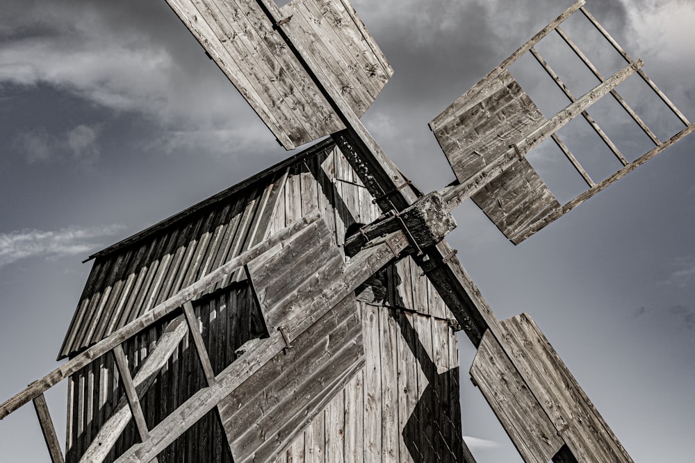 an old wooden windmill with a sky background