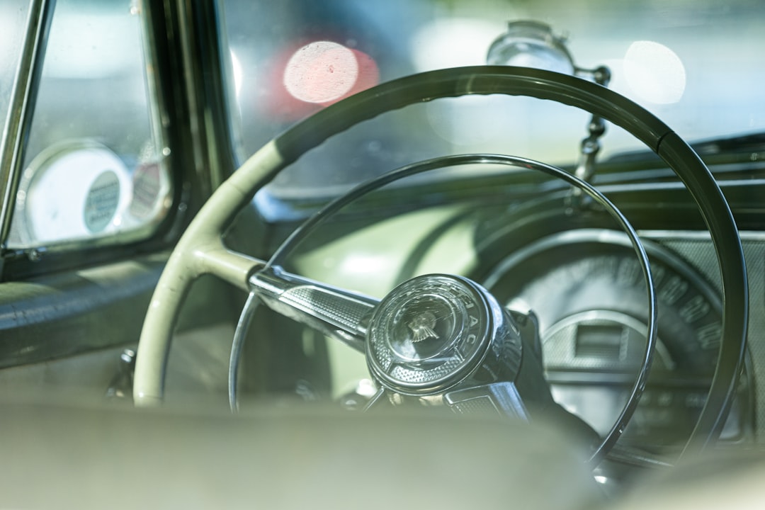 a steering wheel and dashboard of a car, Interior from a vintage American car.