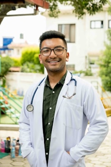 A friendly doctor smiling with a stethoscope in a bright clinic.