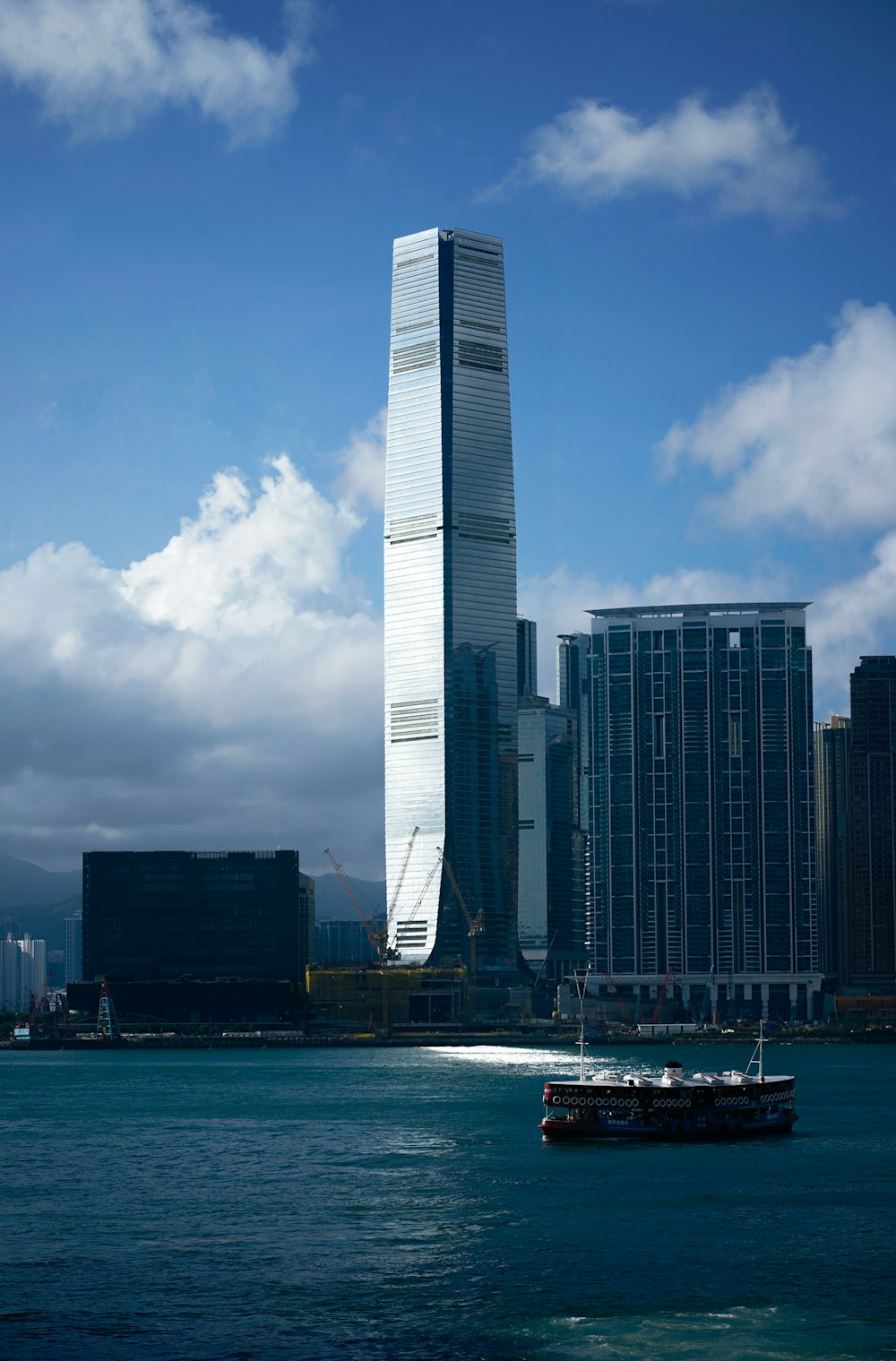 a boat in a body of water near a tall building