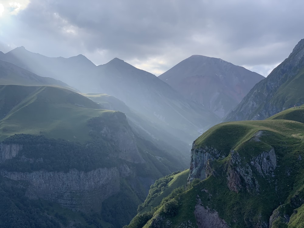 a view of a valley with mountains in the background