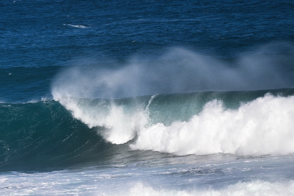 a man riding a wave on top of a surfboard