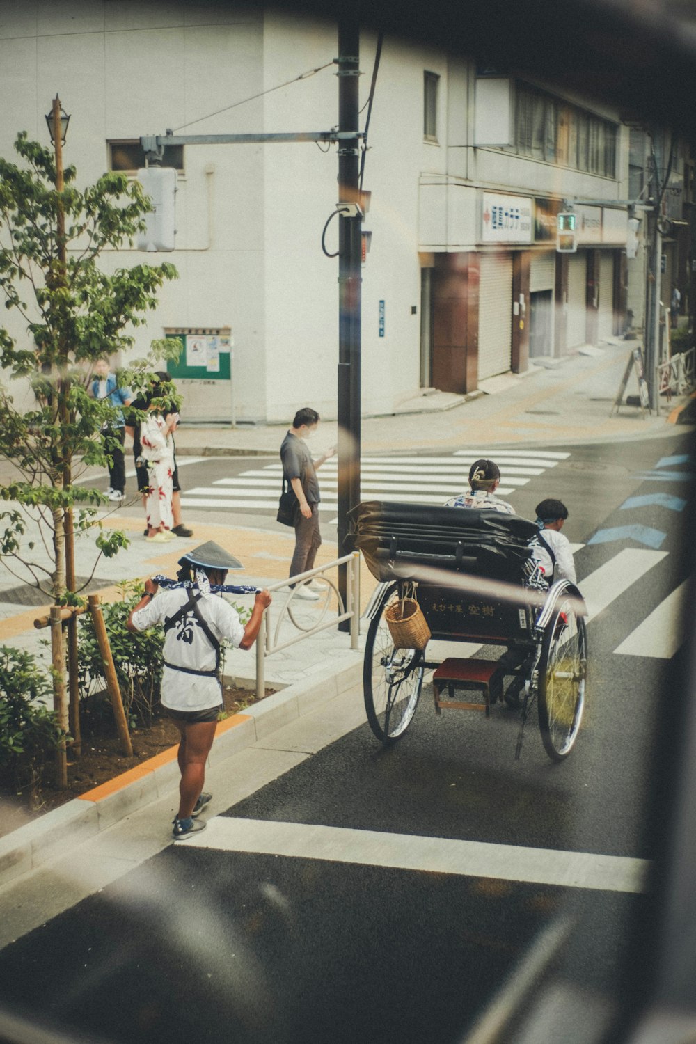 a person riding a horse drawn carriage down a street