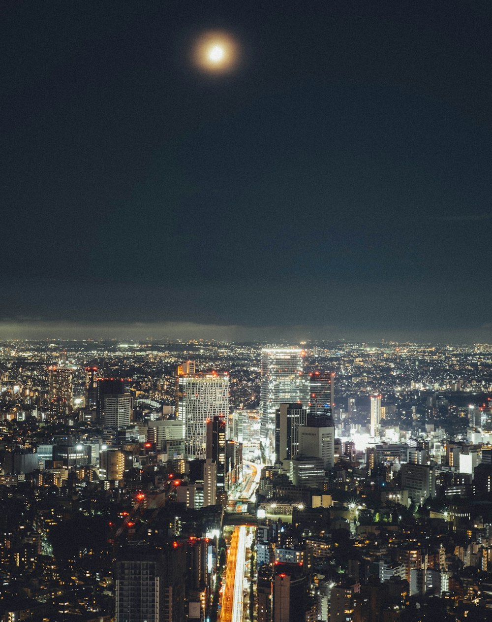 a view of a city at night from the top of a tall building