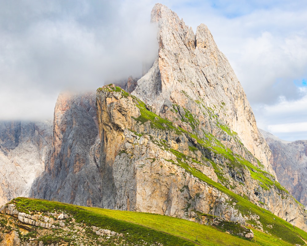 a very tall mountain with a very green grass on it