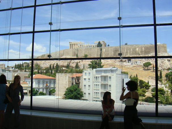 Modern room with large windows and views of the archaeological site.