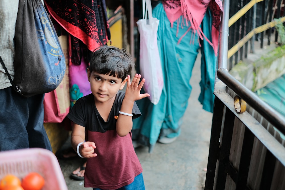 a young boy standing in front of a store