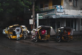 A friendly customer service representative answering calls with a backdrop of electric tricycles.