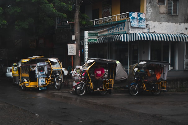 Tricycles displayed in a sunny outdoor setting.