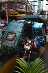 A sleek electric tricycle in vibrant colors parked on a busy Ethiopian street.