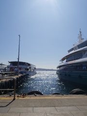 A clean boat docked by the water, gleaming under the sun after a wash.