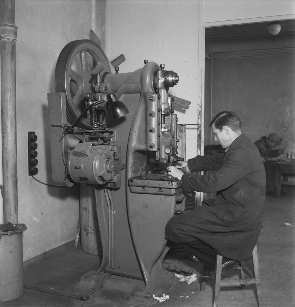 a man working on a machine in a factory