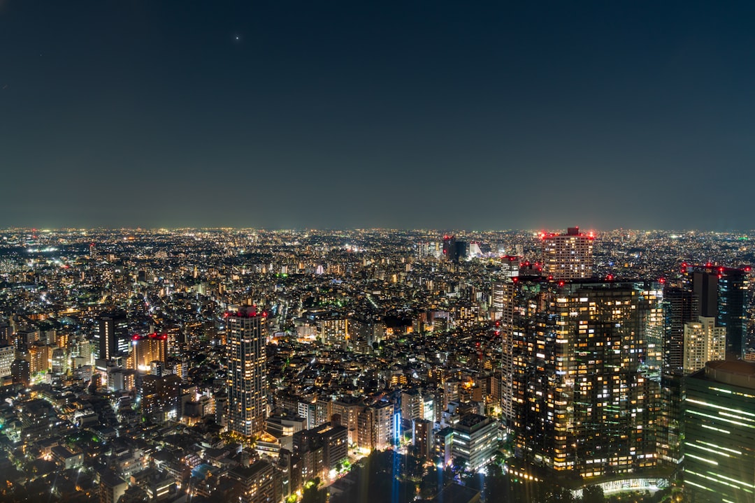 a view of a city at night from the top of a skyscraper,