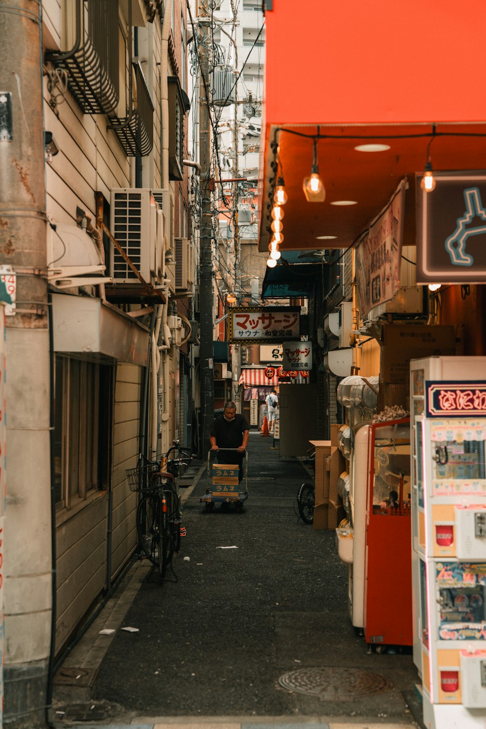 a narrow alley way with signs and signs on the buildings