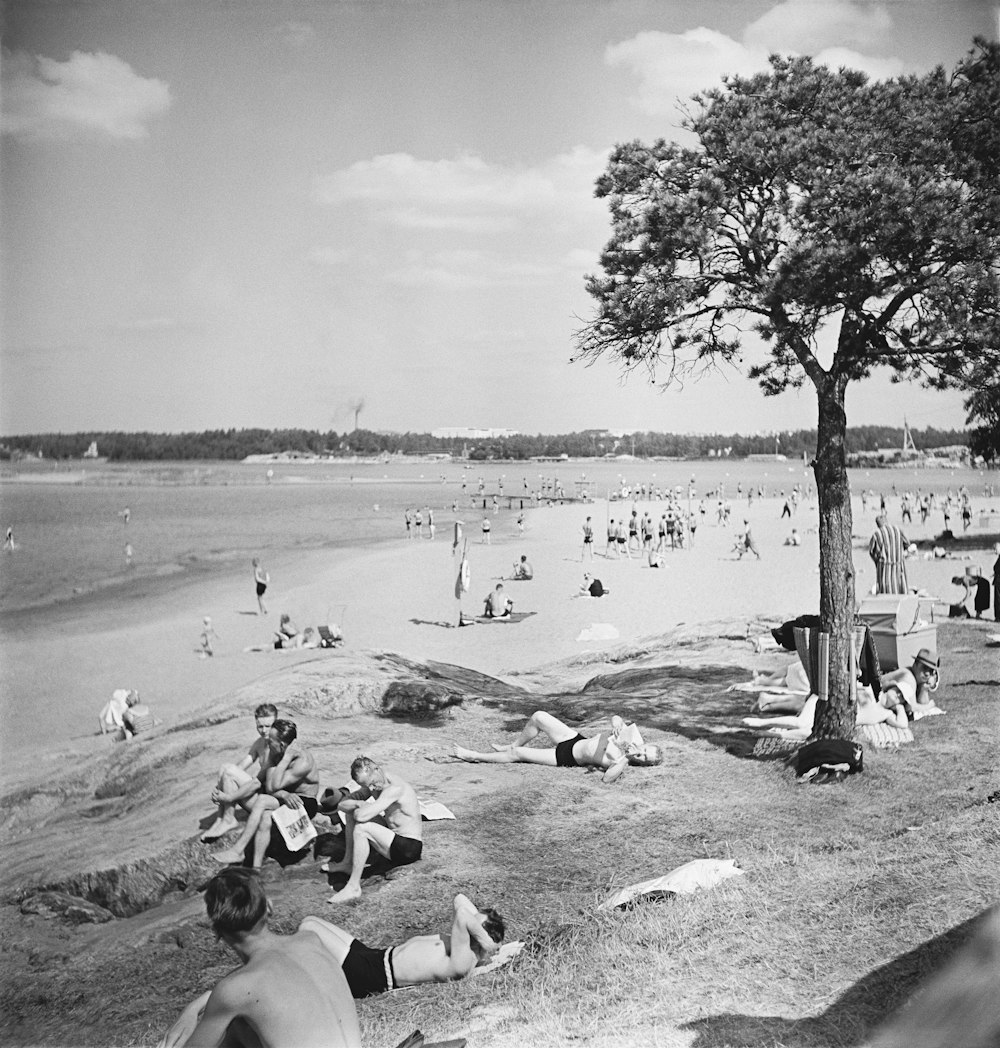 a black and white photo of a crowded beach