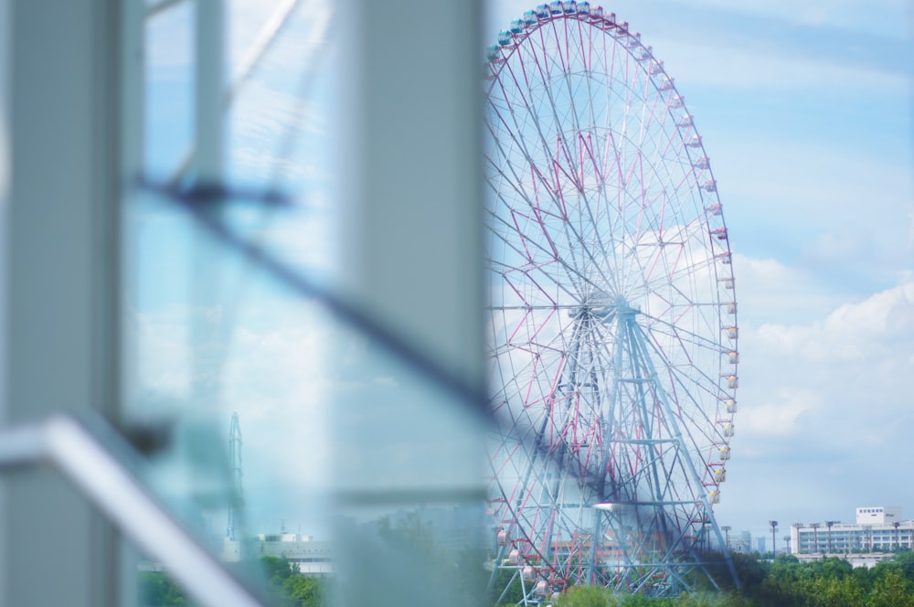 a ferris wheel is seen through a window