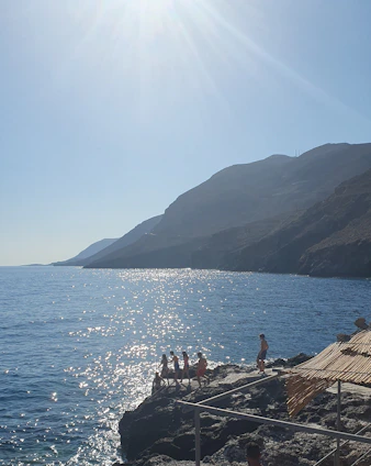 A serene coastal scene showing engineers studying shoreline erosion with measuring instruments at sunrise.