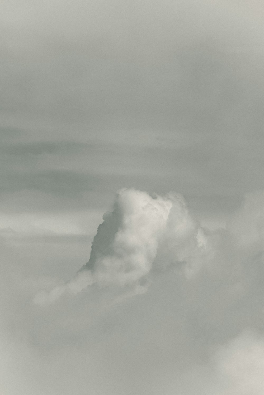 a black and white photo of a plane in the sky