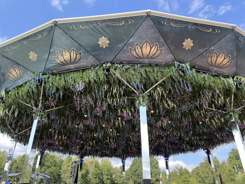 a large umbrella covered in lots of purple flowers