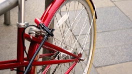 A close-up of a bike lock securing a bicycle to a rack, emphasizing safety and security.