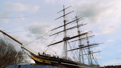 A majestic vessel docked at a bustling port, ready for its next voyage.