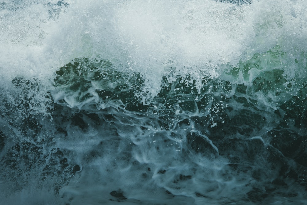 a large wave is breaking over the top of the ocean