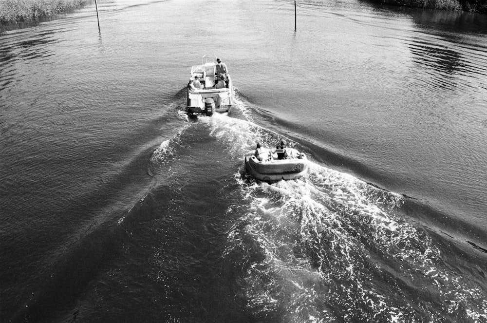 a small boat traveling down a river next to another boat