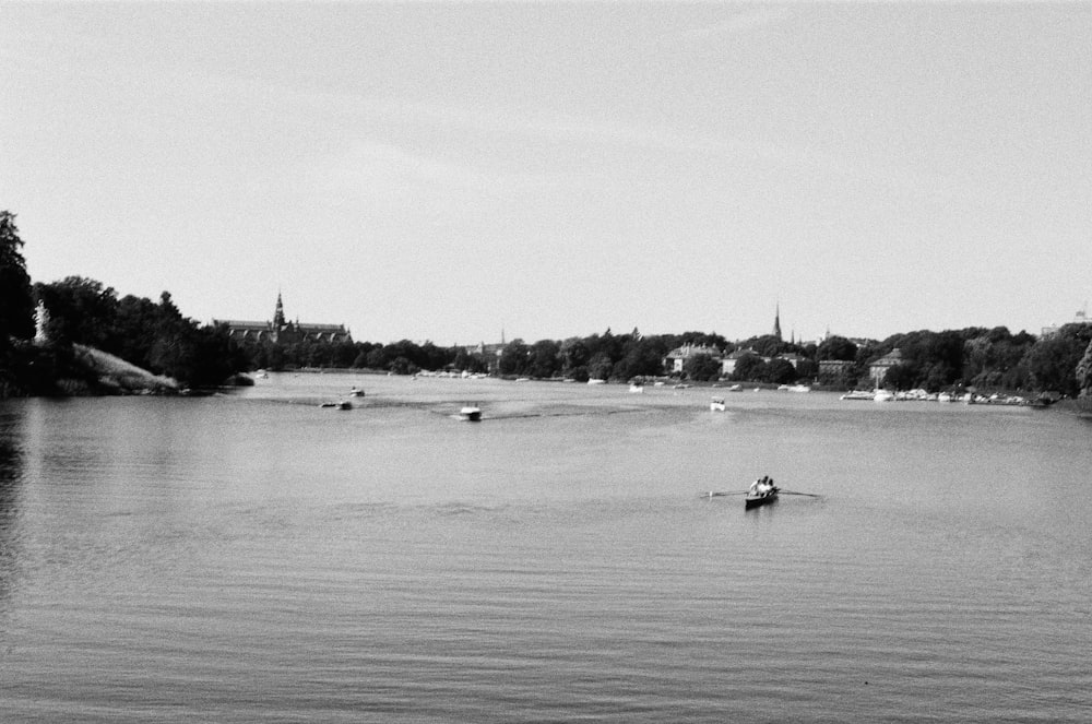 a black and white photo of a person in a kayak
