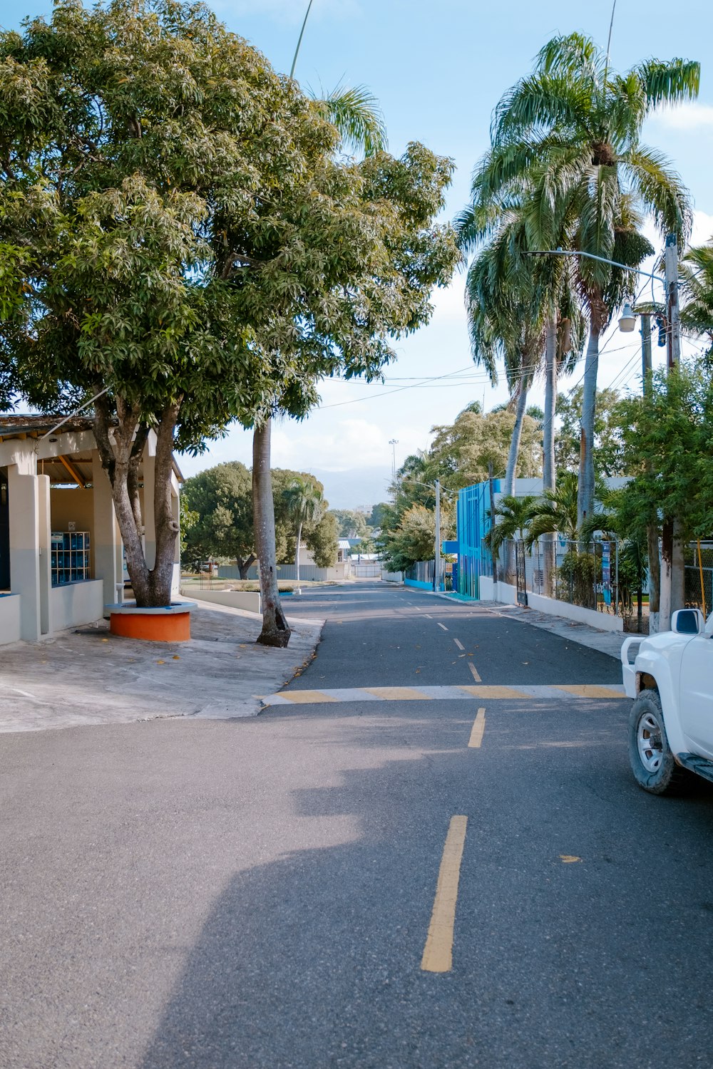 a white truck parked on the side of a road