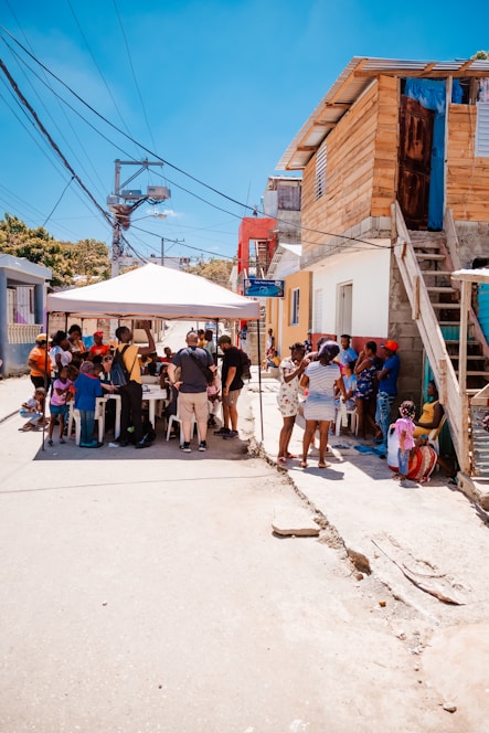A diverse group of neighbors engaging in a lively community conversation outdoors.