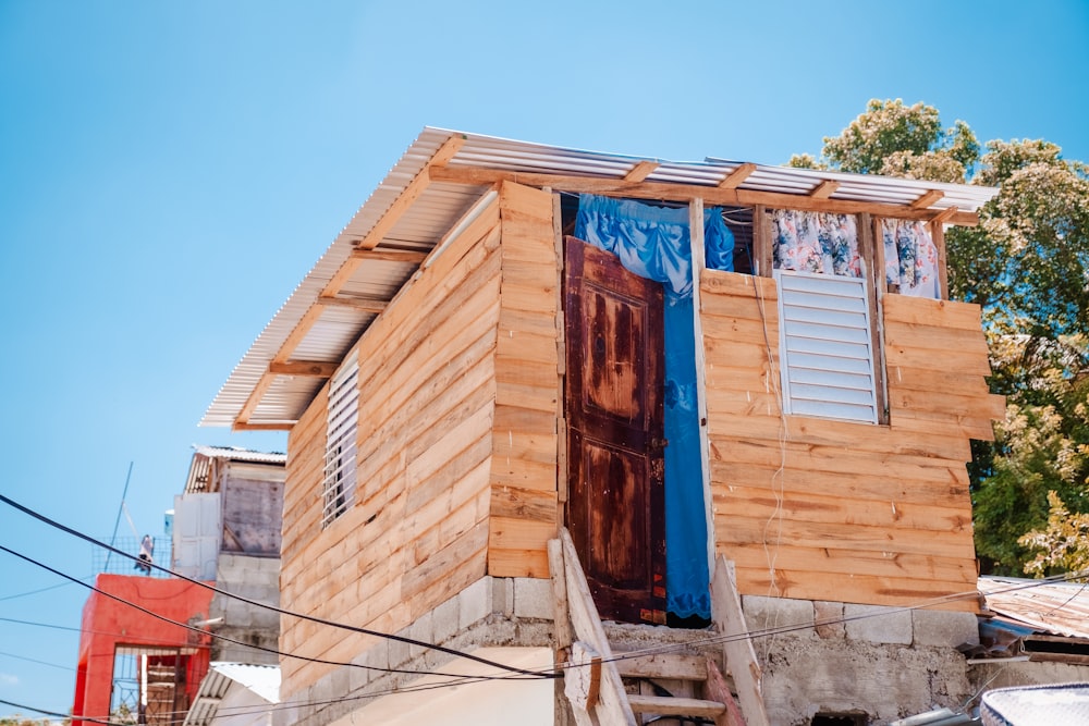 a house made of wood with blue shutters