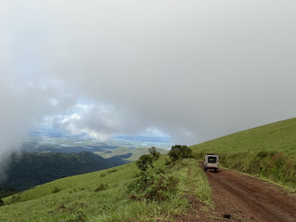 a truck is driving down a dirt road