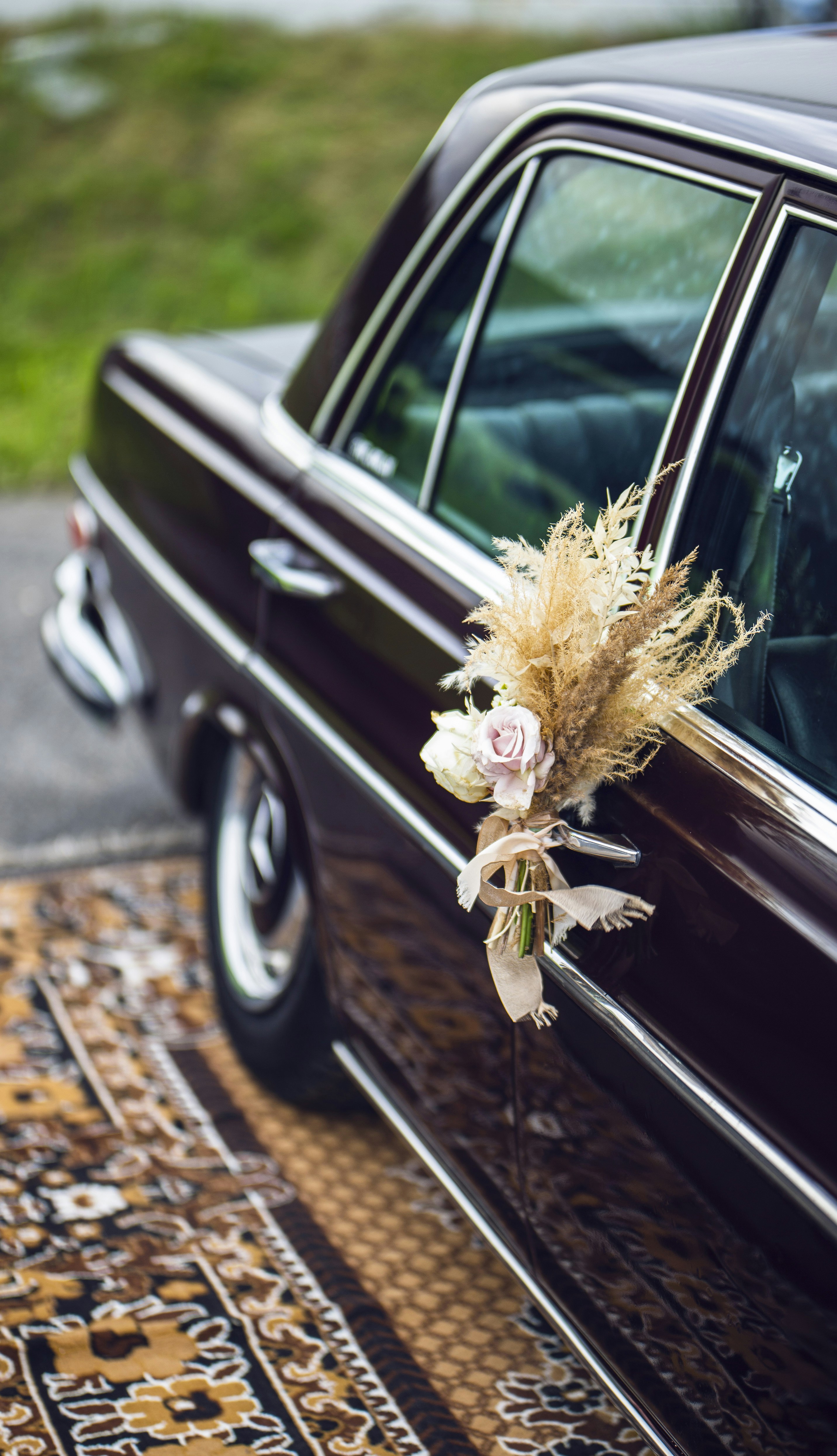 Wedding car decorated with a bouquet of flowers on the hood