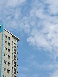 A friendly village office building with blue and green accents under a clear sky.