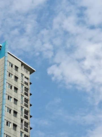 A friendly village office building with blue and green accents under a clear sky.