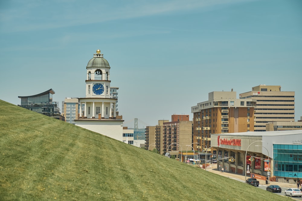 a clock tower on top of a hill in a city