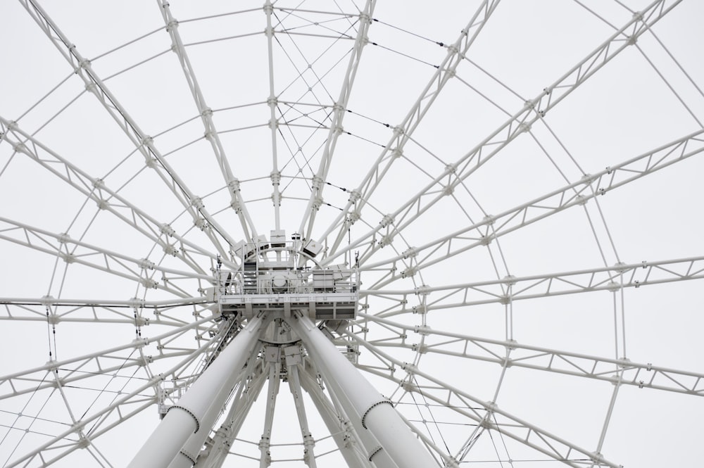 a large white ferris wheel on a cloudy day