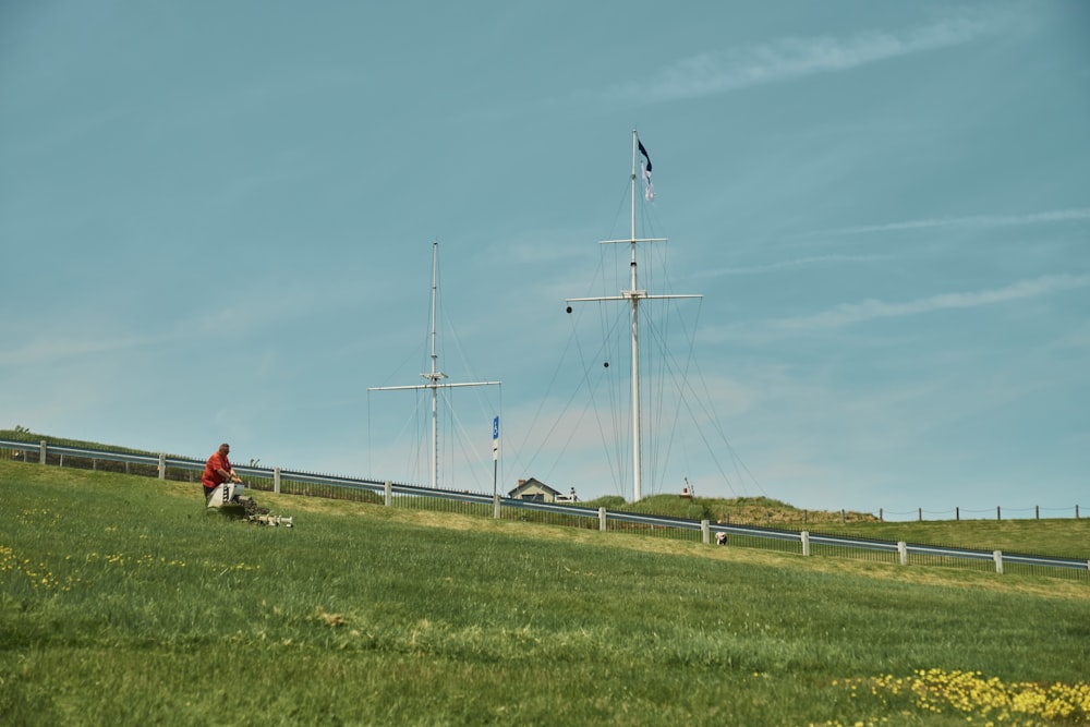 a person sitting on a bench in a field