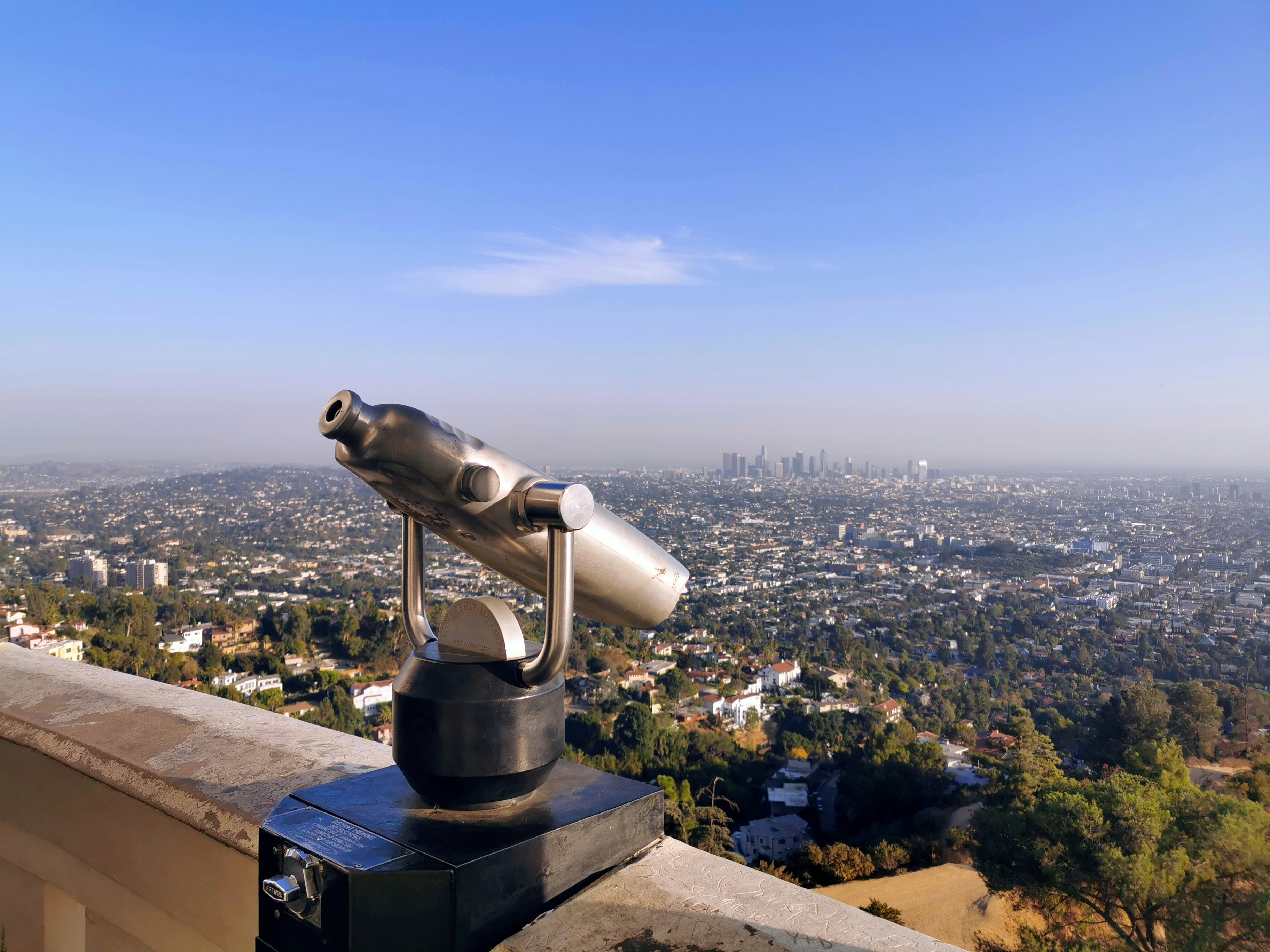 a telescope on top of a building overlooking a city