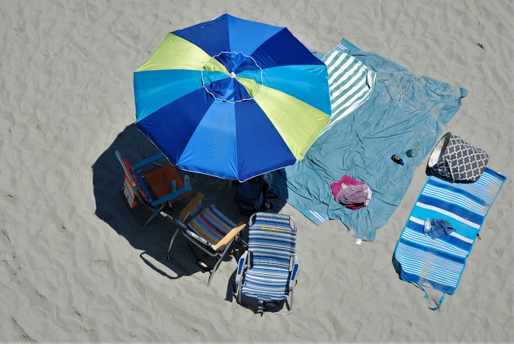 an overhead view of beach chairs and umbrellas on the sand