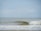 A prototype wave energy device on the water, surrounded by gentle waves.