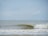 A prototype wave energy device on the water, surrounded by gentle waves.