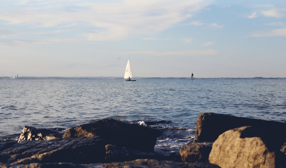 a sailboat in the distance on the water