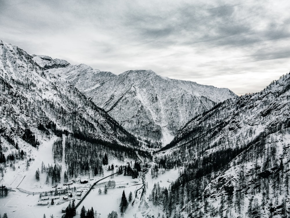 a black and white photo of a snowy mountain