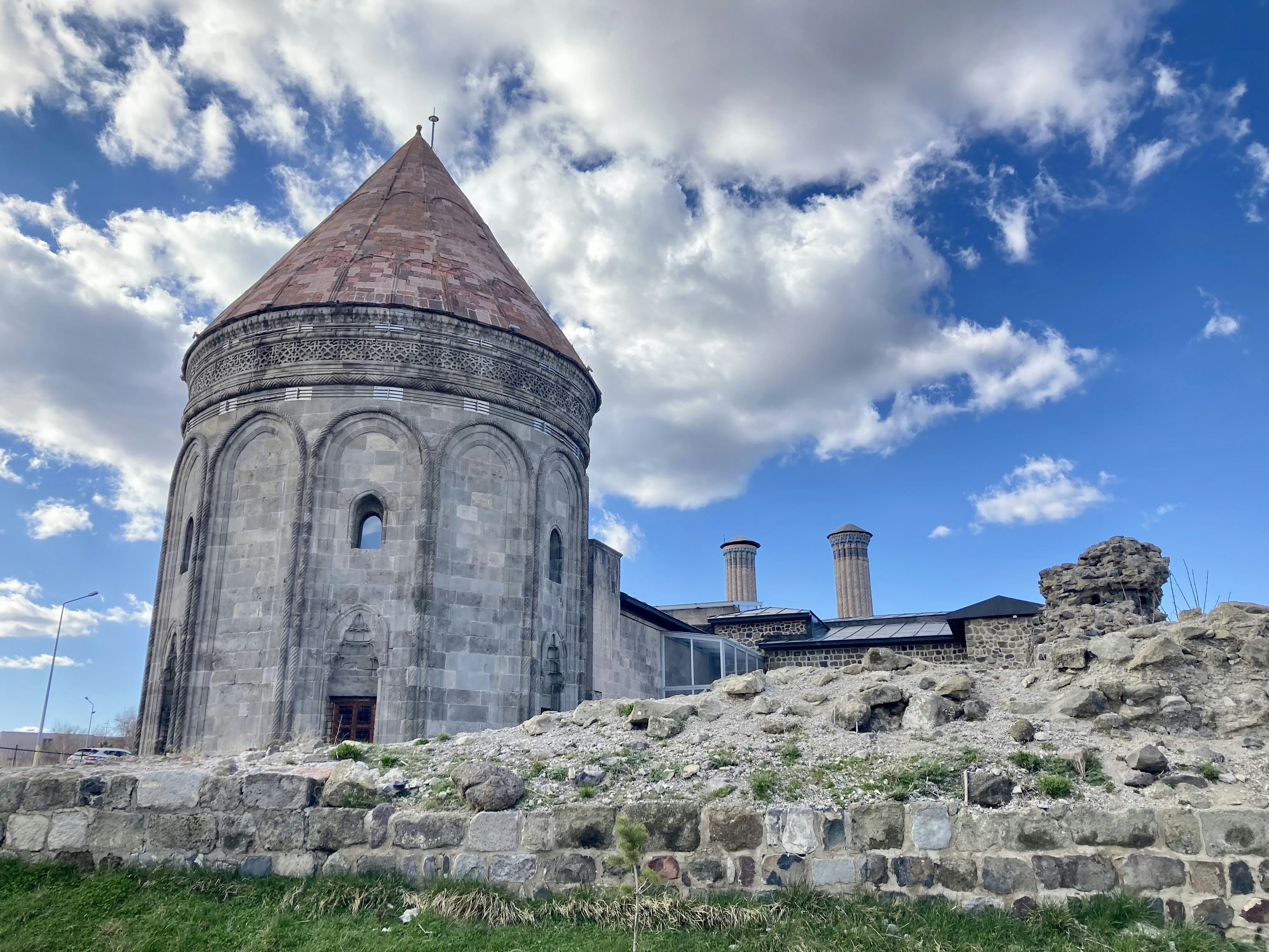 a very old building with a tower and a sky background