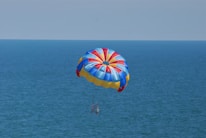 Close-up of hands gripping the vibrant fabric of a playful parachute