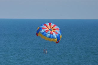 A group of kids lifting a vibrant 5-meter parachute during a school recreation activity