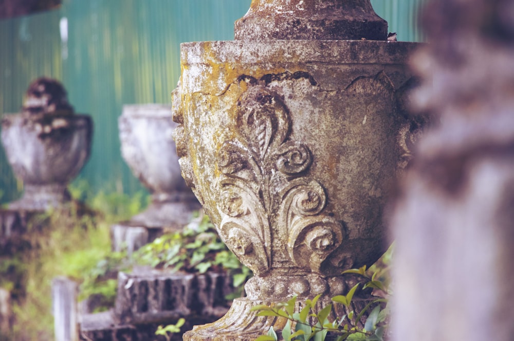 a group of cement urns sitting next to each other